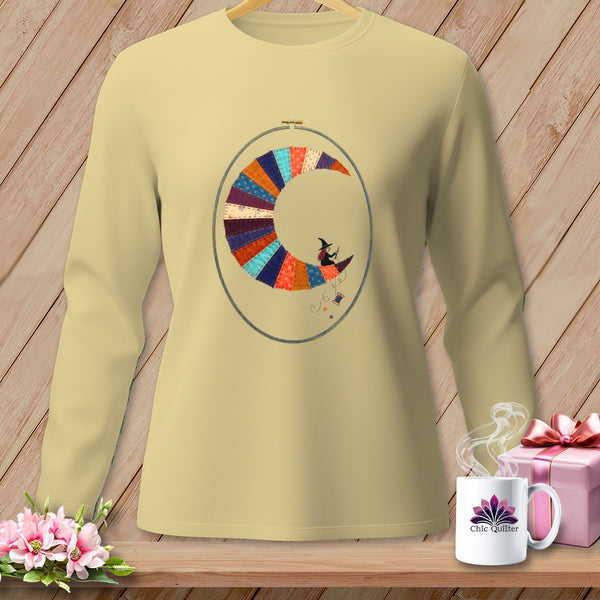 Long-sleeve shirt with a colorful patchwork moon and witch design within an embroidery hoop.