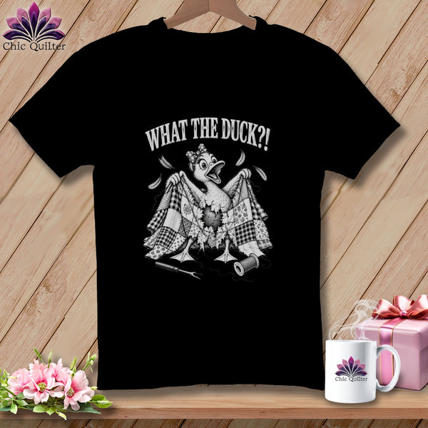 Black t-shirt featuring a cartoon duck holding a torn quilt with the text WHAT THE DUCK?!