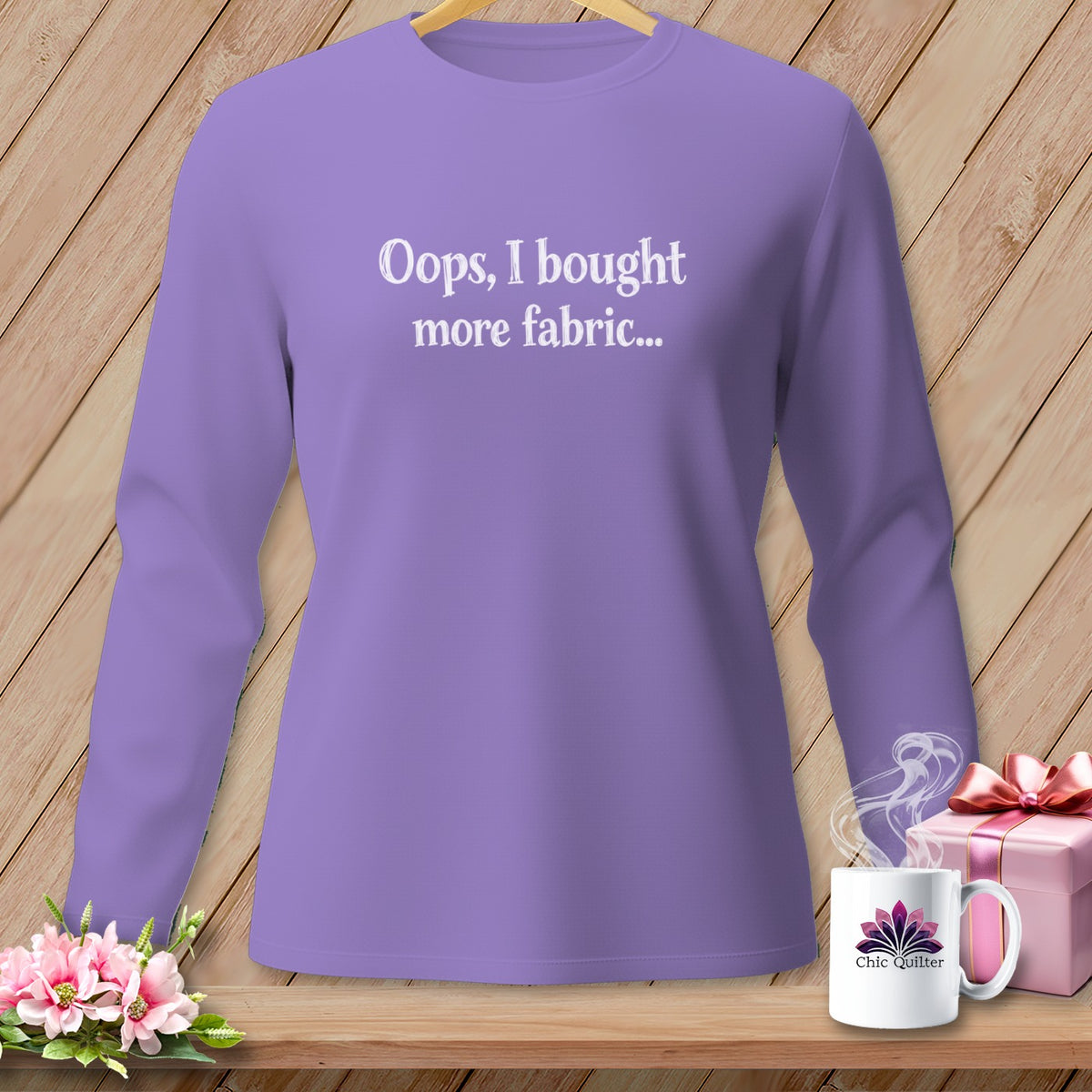 Purple long-sleeve shirt with white text that says "Oops, I bought more fabric..."