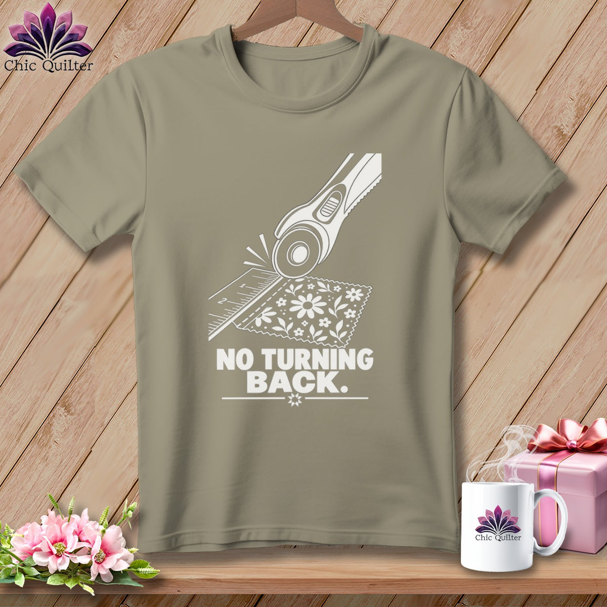 T-shirt with rotary cutter, ruler, fabric, and "NO TURNING BACK." text.
