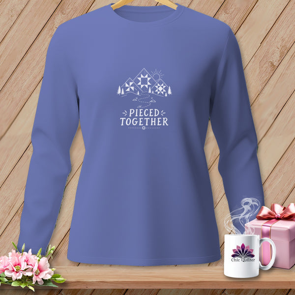 Purple long-sleeve shirt with mountains, sun, and text "PIECED TOGETHER".