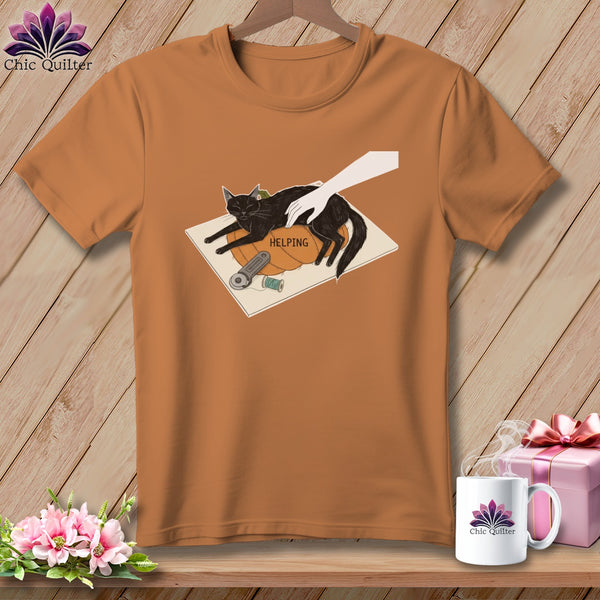 Black cat on pumpkin with sewing notions and text "HELPING".