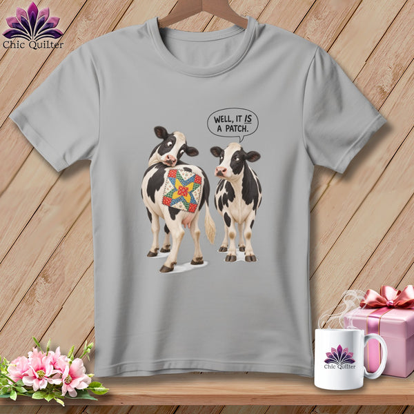Two cows with a quilt patch on one's backside, one says "Well, it is a patch."