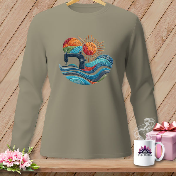 Long sleeve shirt with a sewing machine, colorful fabric waves, and sun graphic.