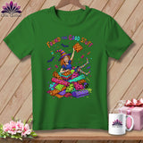 Green t-shirt with witch surrounded by fabric rolls and 