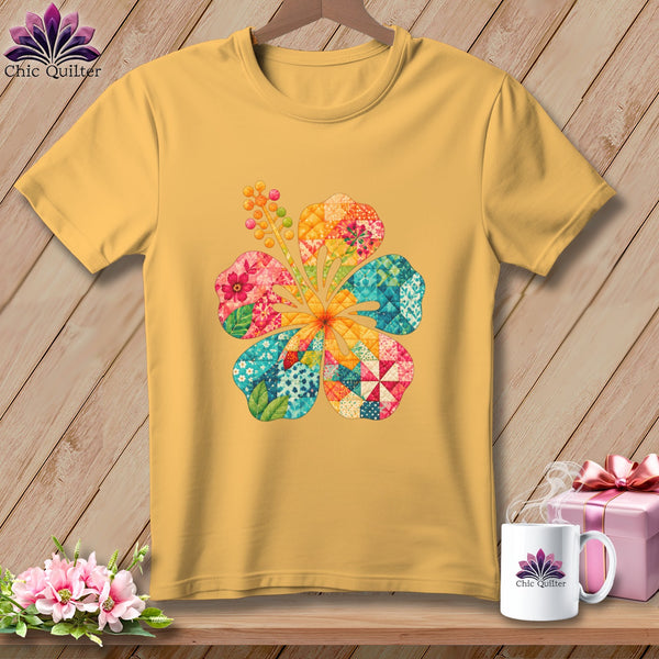 A yellow t-shirt featuring a colorful patchwork hibiscus flower graphic on the chest.