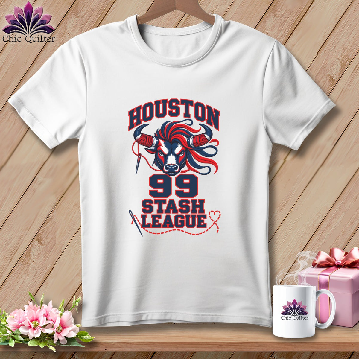 A white t-shirt hanging on a wooden background, featuring a graphic of a bull's head, the text Houston 99 Stash League, and sewing-related details.