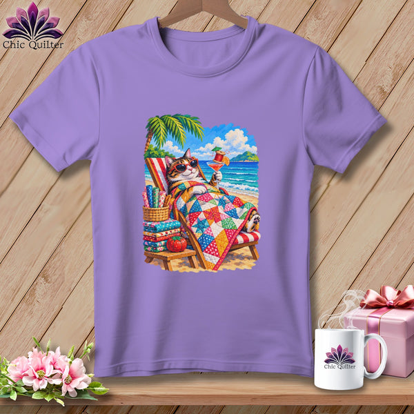 A purple crewneck t-shirt featuring a graphic of a cat relaxing on a beach lounge chair.
