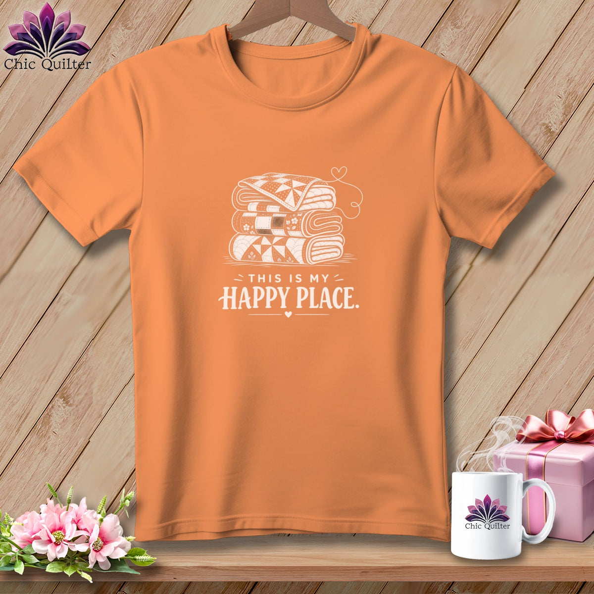 Orange t-shirt with stack of quilts graphic and text "THIS IS MY HAPPY PLACE."