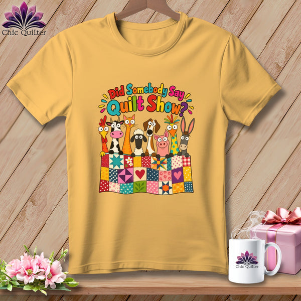 Yellow t-shirt featuring a cartoon graphic of farm animals peeking over a colorful patchwork quilt.