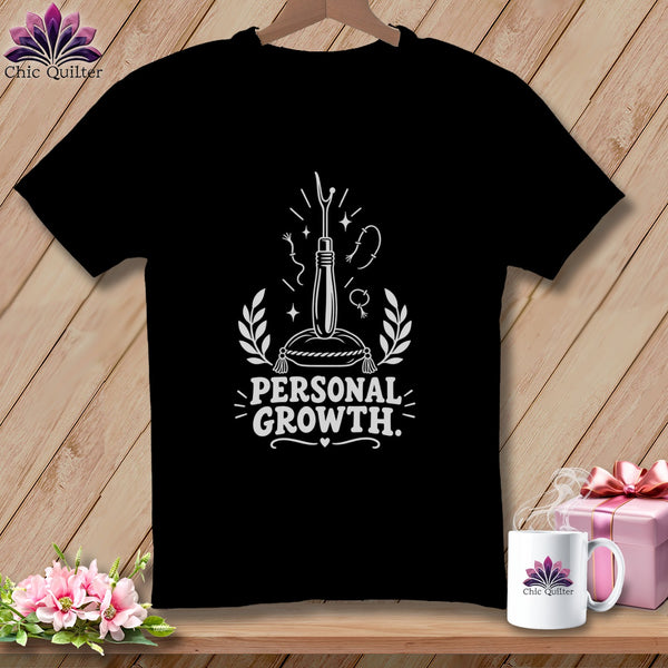 Black t-shirt with "Personal Growth" text and sewing tools graphic.