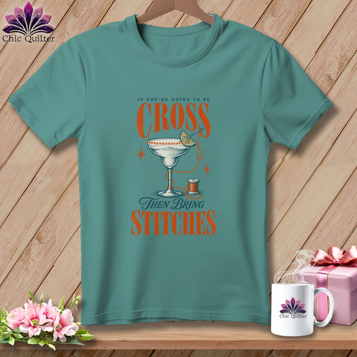 Teal t-shirt with "If You're Going to Be Cross Then Bring Stitches" design.