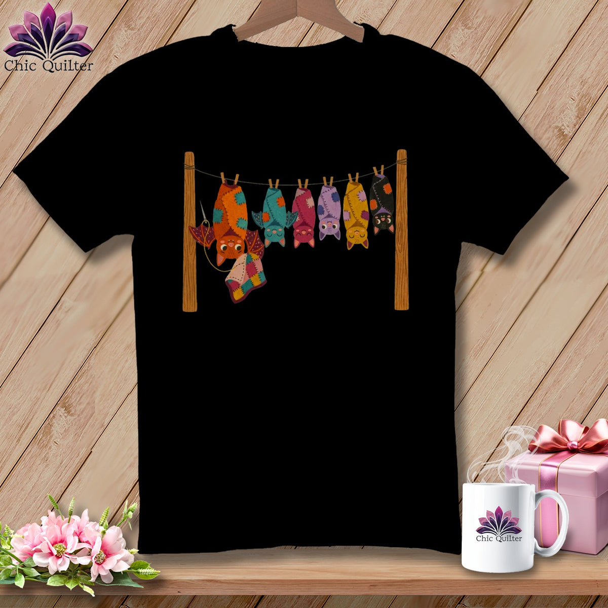 Black t-shirt with line of colorful patchwork bats hanging on a clothesline.