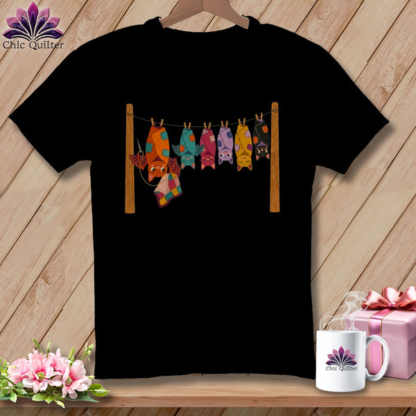 Black t-shirt with line of colorful patchwork bats hanging on a clothesline.