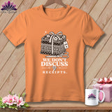 Orange t-shirt with stacked fabric, scissors, and 