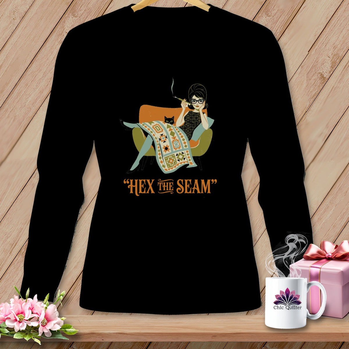 Black long-sleeve shirt with a woman and cat graphic and text "HEX THE SEAM".