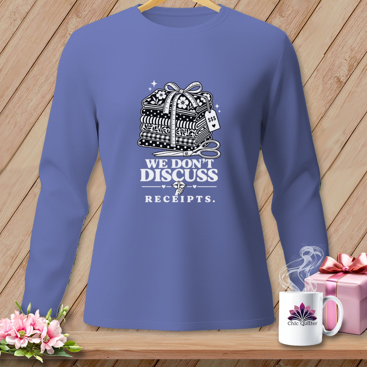 Purple long-sleeve shirt with quilting supplies graphic and "We Don't Discuss Receipts" text.