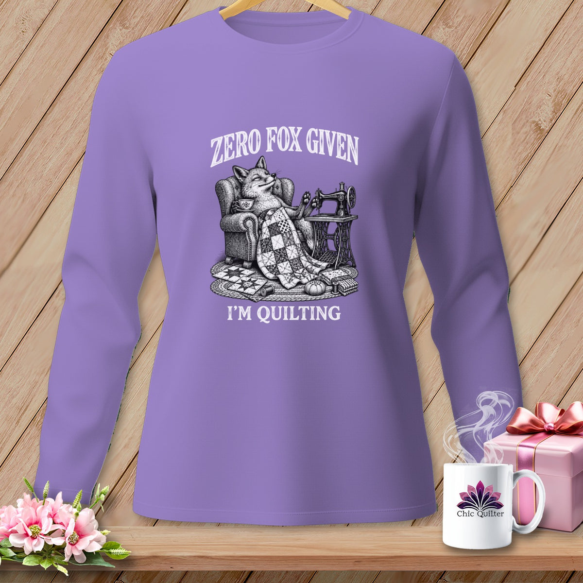 Lavender long-sleeve shirt with a fox knitting, "Zero Fox Given," and "I'm Quilting."