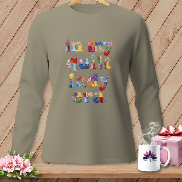 Long sleeve t-shirt with "in my quilt lady era" text in patchwork fabric letters.