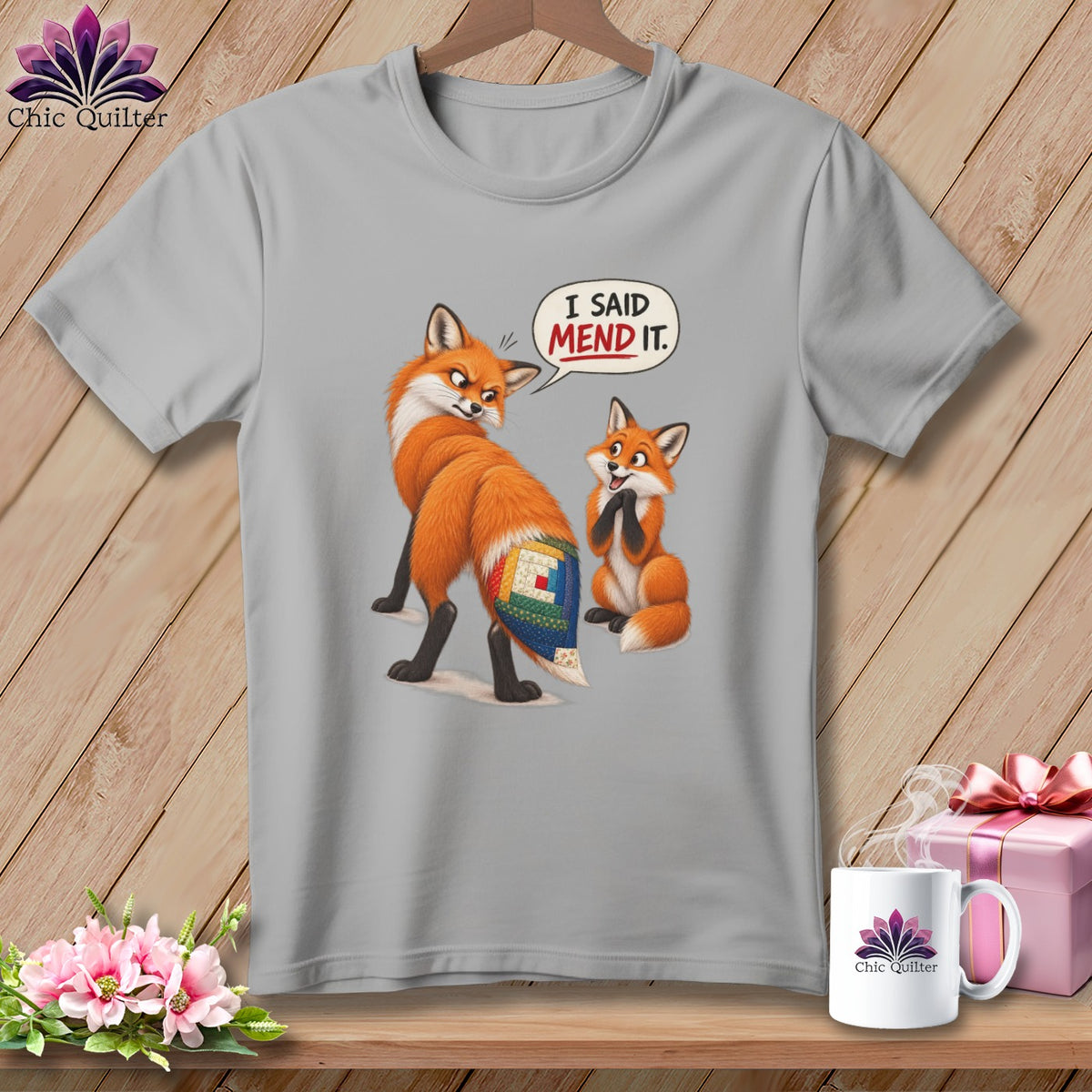 Grey t-shirt with two foxes, one says "I said mend it."