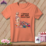 Peach t-shirt with llama tangled in yarn and text 