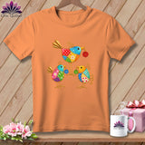 An orange crewneck t-shirt featuring a colorful graphic of three whimsical birds holding buttons.