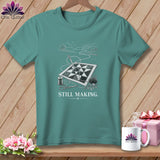 Teal t-shirt with a sewing graphic and the text 