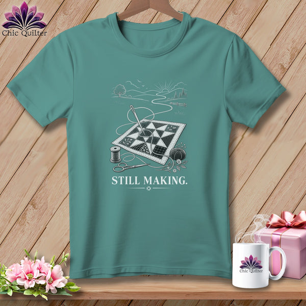 Teal t-shirt with a sewing graphic and the text "STILL MAKING."