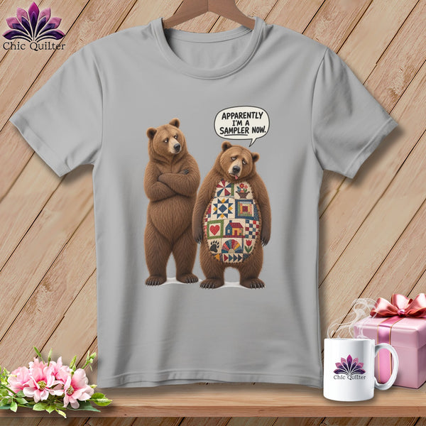 Two bears on a gray t-shirt, one with a quilt pattern, and a speech bubble.