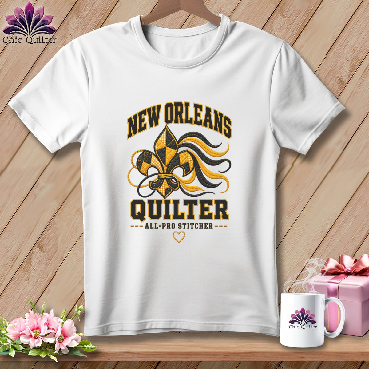 White crewneck t-shirt with black and gold New Orleans Quilter graphic featuring a fleur-de-lis design.