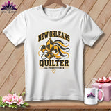 White crewneck t-shirt with black and gold New Orleans Quilter graphic featuring a fleur-de-lis design.