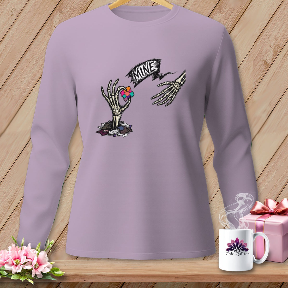 Skeleton hands reaching for a colorful heart graphic with the word "MINE".