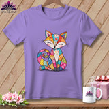 A purple crewneck t-shirt featuring a colorful patchwork fox graphic, hanging on a wooden background.