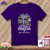 Purple t-shirt with a graphic of stacked fabric, scissors, and the text 
