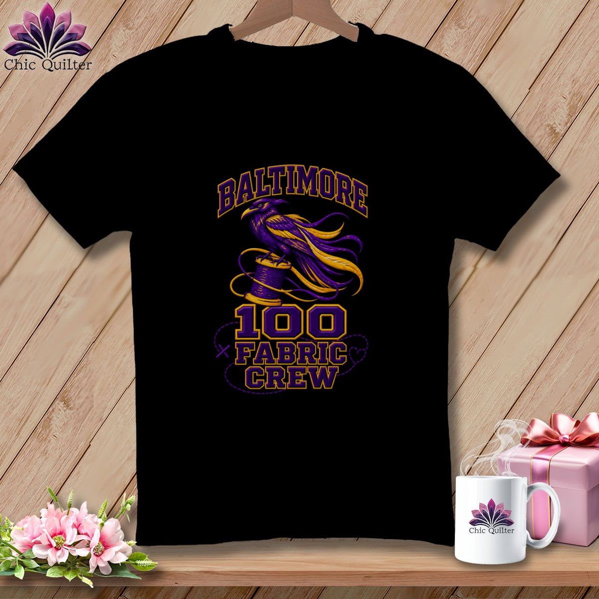 A black t-shirt features a purple and yellow raven on a spool, with text reading Baltimore 100 Fabric Crew.