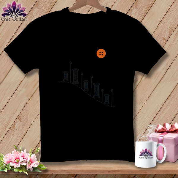 Black t-shirt with orange button and spools graphic, "Chic Quilter" logo.