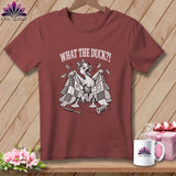Maroon t-shirt featuring a cartoon duck holding up a tattered quilt with the text WHAT THE DUCK?!