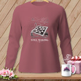 Long-sleeve shirt with a quilt, sewing supplies, and text 