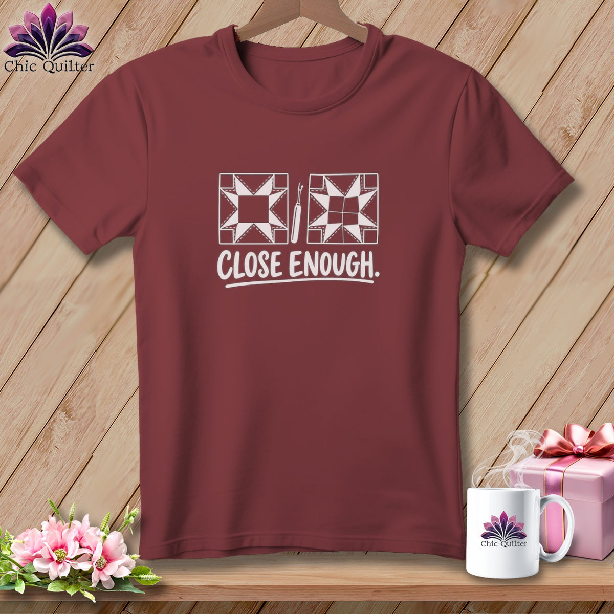 Maroon t-shirt with two quilt blocks and "CLOSE ENOUGH" text.