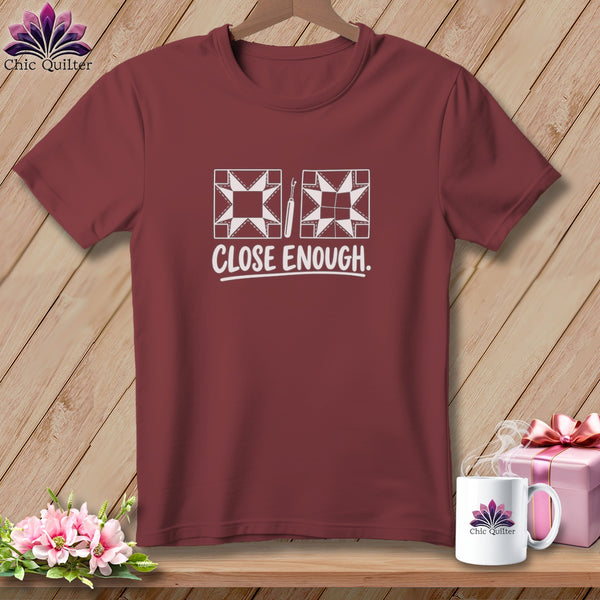 Maroon t-shirt with two quilt blocks and "CLOSE ENOUGH" text.