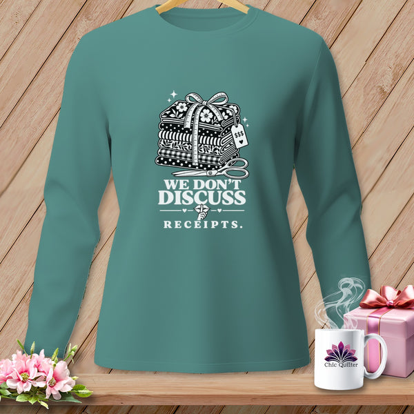 Teal long-sleeve shirt with stack of fabric, scissors, and "We Don't Discuss Receipts" text.
