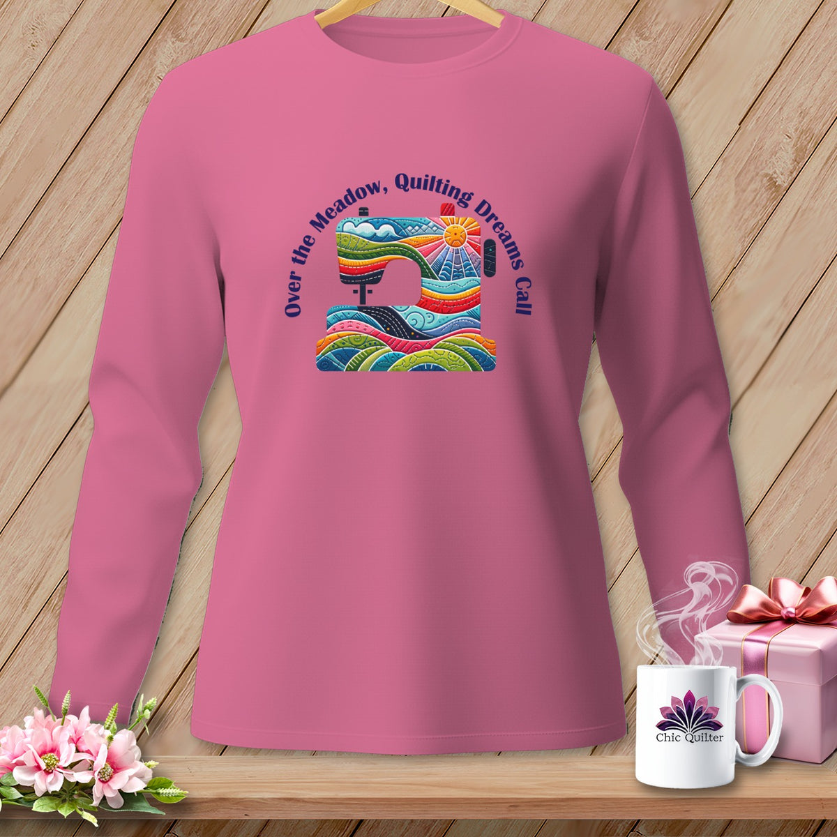 Pink long-sleeve shirt with a colorful sewing machine graphic and text.