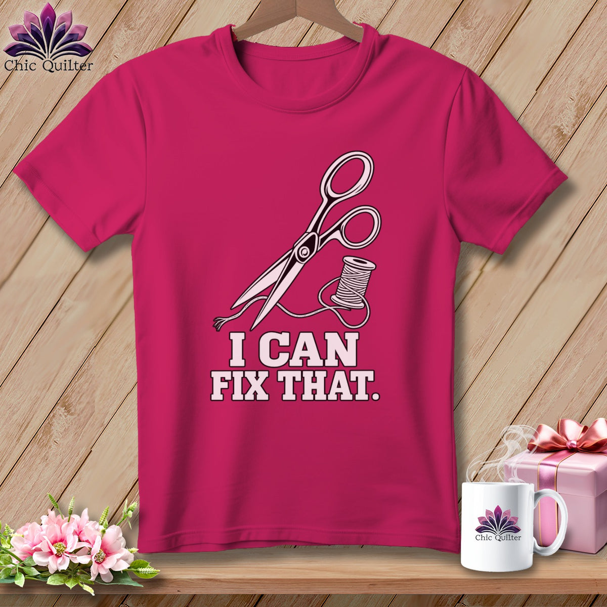 Pink t-shirt with scissors, thread, and "I CAN FIX THAT." text.