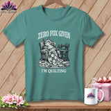 T-shirt with a fox relaxing in a chair with a quilt and sewing machine.