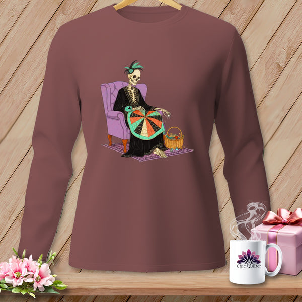 Skeleton in chair with hoop and basket on a long sleeve shirt.