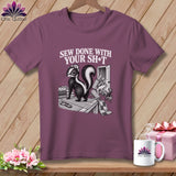Skunk on a cutting mat with fabric, text 