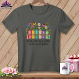 Dark gray t-shirt with a graphic of fabric rolls, flowers, and the text 