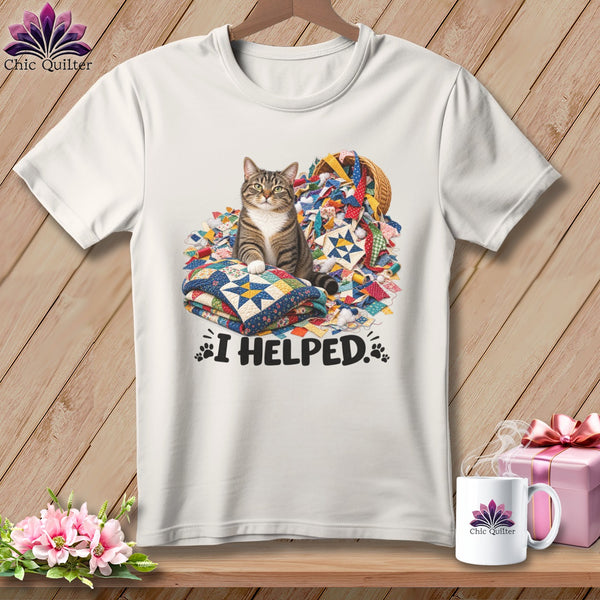 Tabby cat sits on quilt stacks near basket of quilting scraps, with "I HELPED." text.