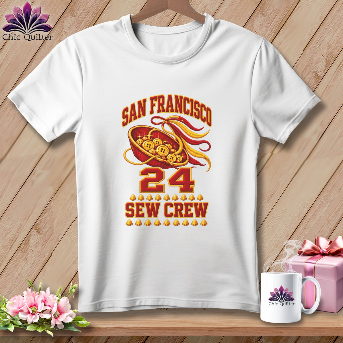 White t-shirt featuring San Francisco 24 Sew Crew graphics on a wooden background with a mug and gift.