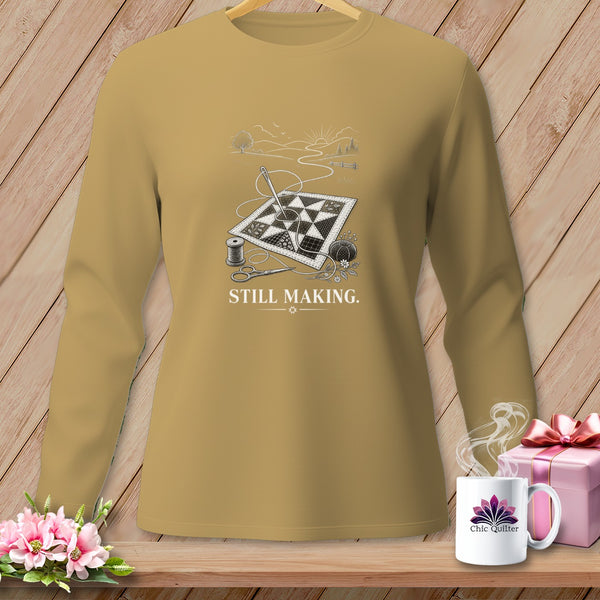 Long sleeve shirt with quilting design, scissors, needle, thread, and "STILL MAKING." text.